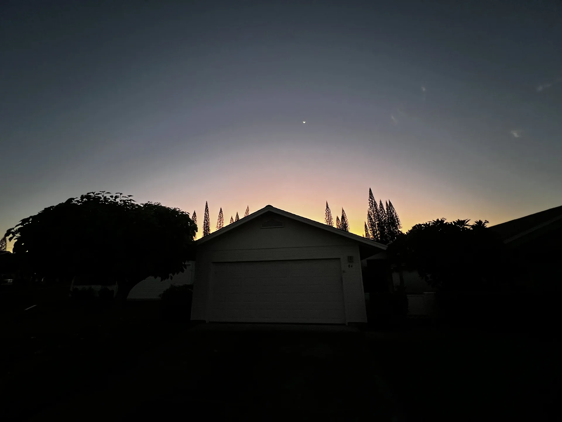 Pines I home silhouetted beneath an evening Kona sky